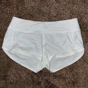 White Lululemon Speed Up running shorts.